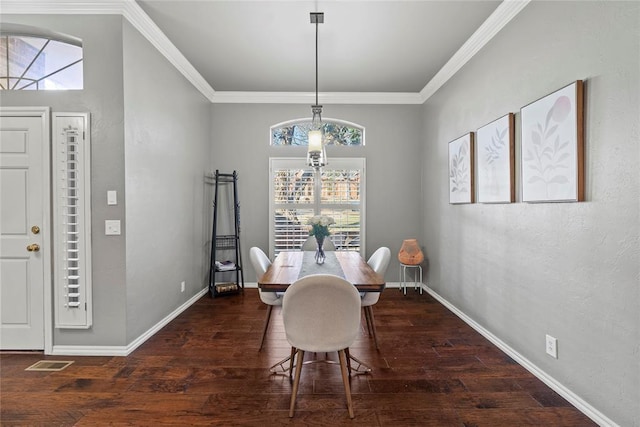 dining area featuring crown molding and dark wood-type flooring