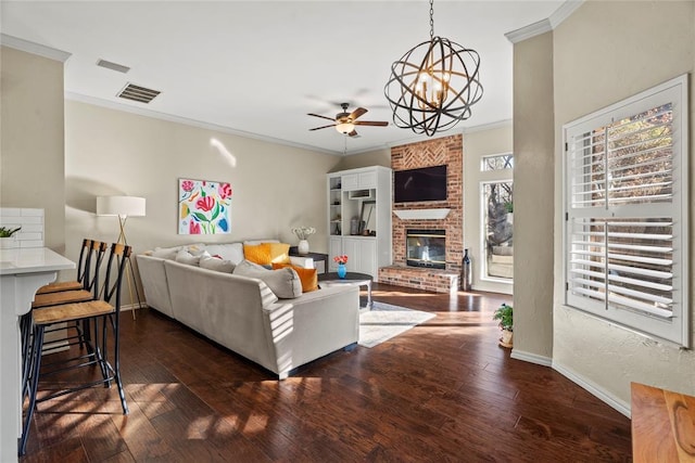 living room featuring crown molding, a healthy amount of sunlight, and dark wood-type flooring