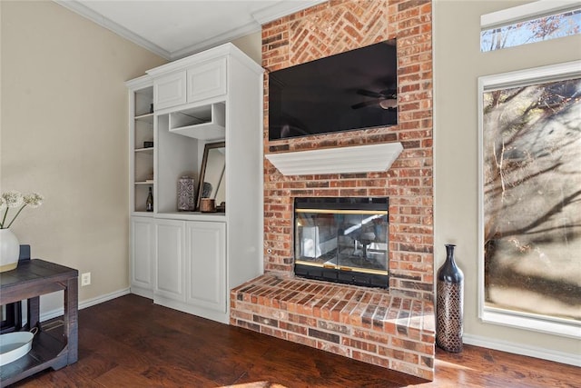 living room with crown molding, a fireplace, and hardwood / wood-style floors