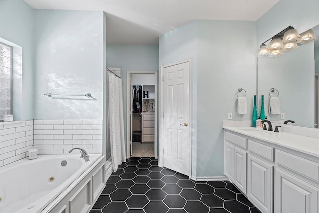 bathroom with vanity, tile patterned floors, and a bathing tub