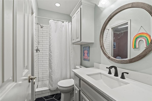 bathroom featuring tile patterned flooring, vanity, curtained shower, and toilet