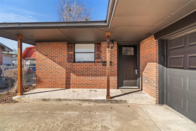 doorway to property featuring a carport