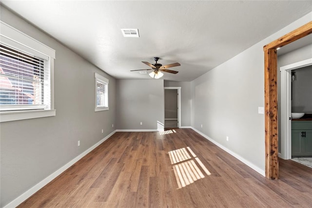 interior space with ceiling fan and hardwood / wood-style floors