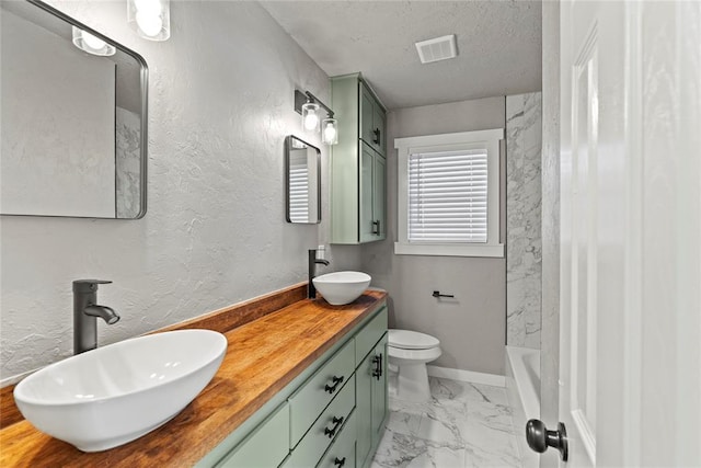 full bathroom with vanity, toilet, a textured ceiling, and shower / bath combination