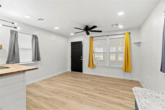 interior space featuring light hardwood / wood-style floors and ceiling fan