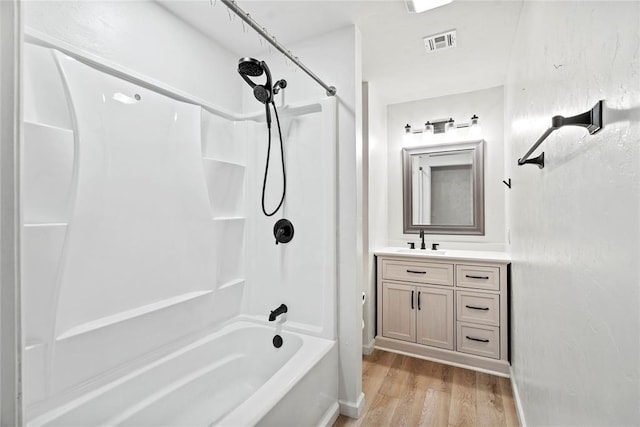 bathroom with vanity,  shower combination, and wood-type flooring