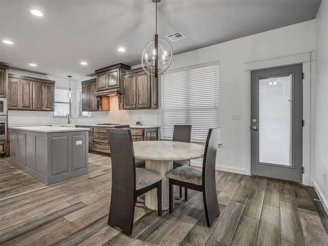 dining space with sink and a chandelier