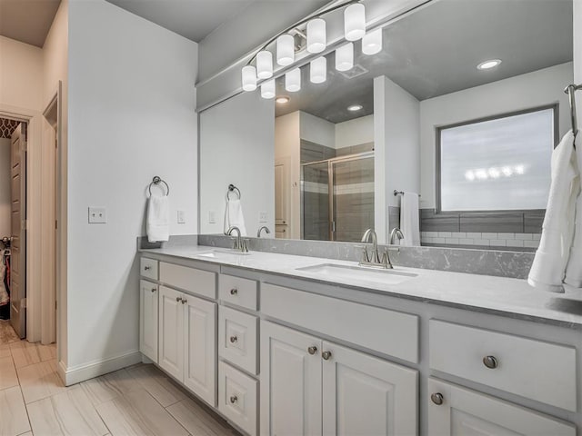 bathroom featuring walk in shower and vanity