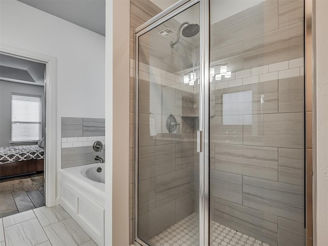 bathroom featuring shower with separate bathtub