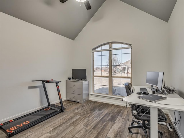 office featuring ceiling fan, hardwood / wood-style floors, and high vaulted ceiling