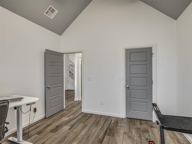 office space with hardwood / wood-style flooring and high vaulted ceiling