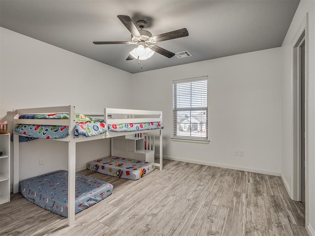 unfurnished bedroom with ceiling fan and light hardwood / wood-style floors