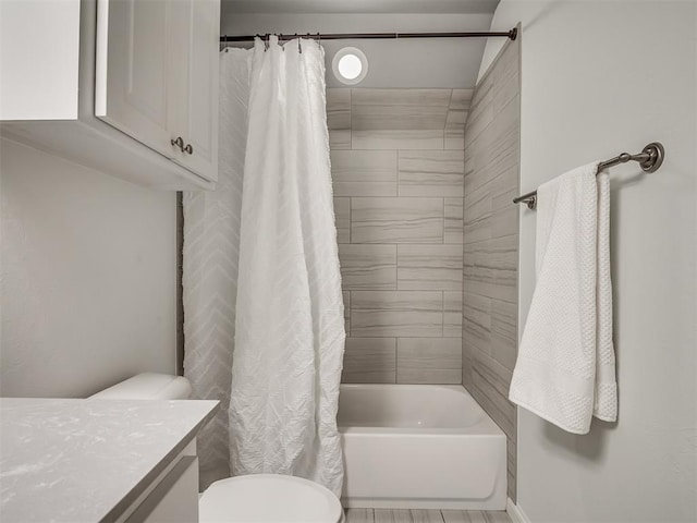 full bathroom featuring toilet, vanity, and shower / bathtub combination with curtain