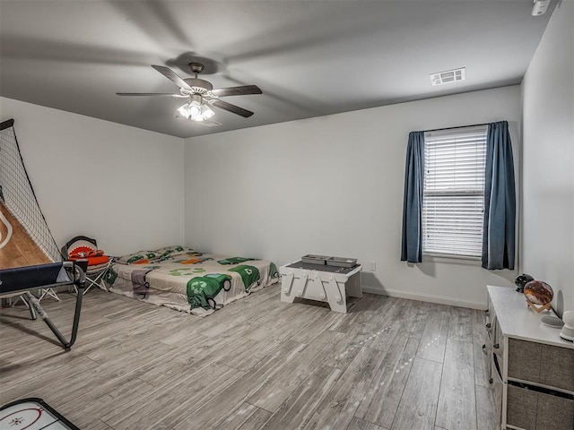 bedroom with ceiling fan and light hardwood / wood-style flooring