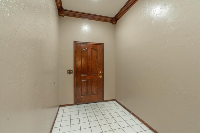 doorway with ornamental molding and light tile patterned flooring