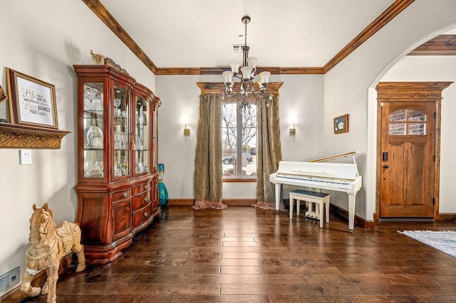 living area with crown molding, arched walkways, and wood-type flooring