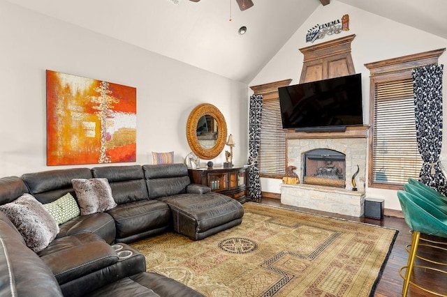 living room with ceiling fan, high vaulted ceiling, wood finished floors, and a fireplace