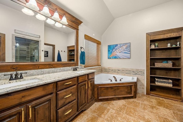 full bath featuring lofted ceiling, a garden tub, a stall shower, and a sink