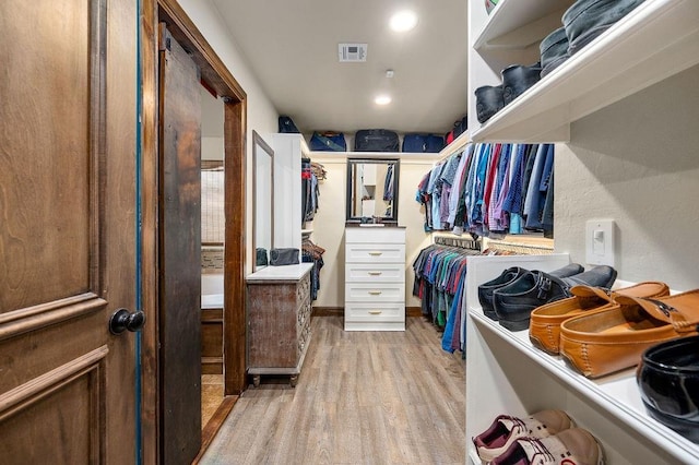 spacious closet featuring light wood-type flooring and visible vents