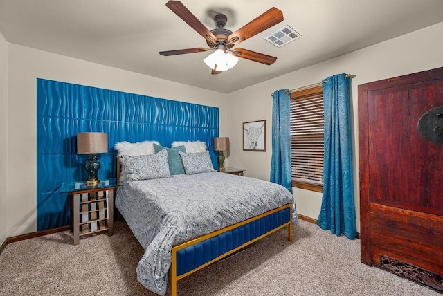 carpeted bedroom featuring a ceiling fan, visible vents, and baseboards