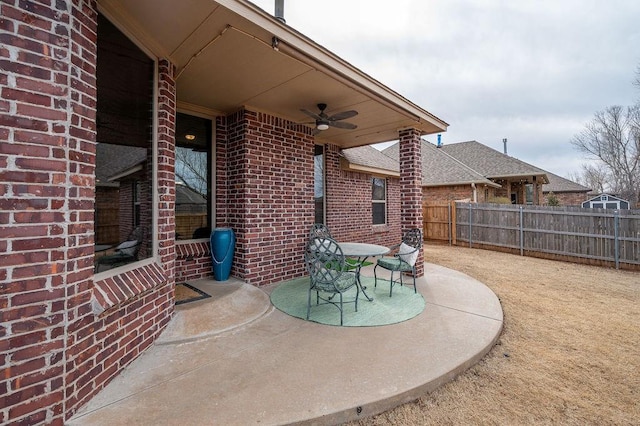 view of patio featuring ceiling fan and fence