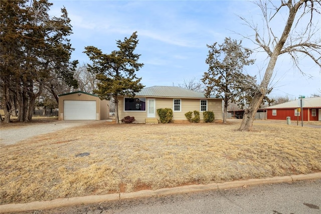 ranch-style home with an outbuilding and a garage