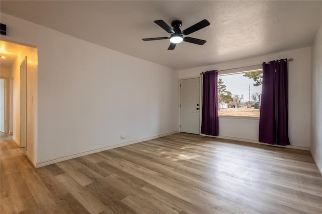 unfurnished room featuring light hardwood / wood-style floors and ceiling fan