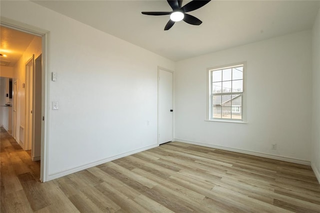 spare room with light wood-type flooring and ceiling fan