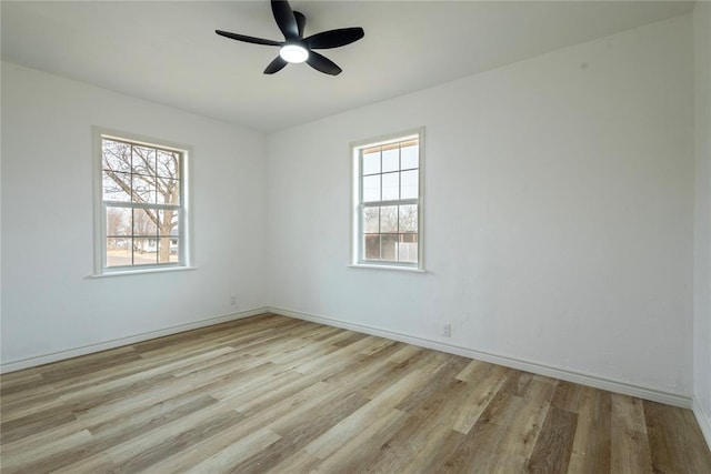 unfurnished room featuring ceiling fan, light hardwood / wood-style flooring, and a healthy amount of sunlight