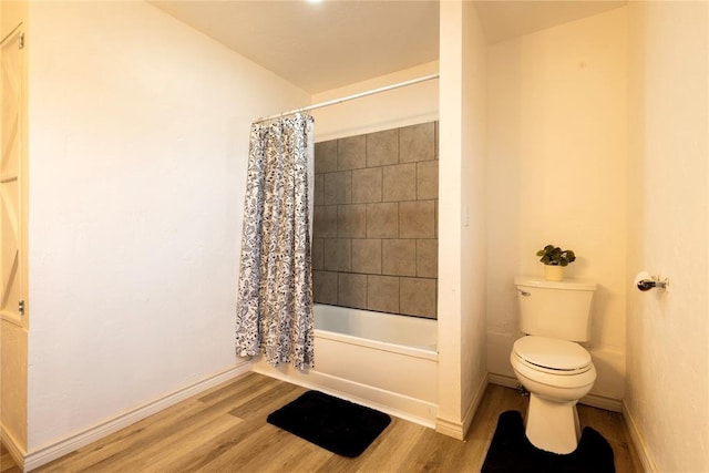 bathroom featuring wood-type flooring, toilet, and shower / bathtub combination with curtain