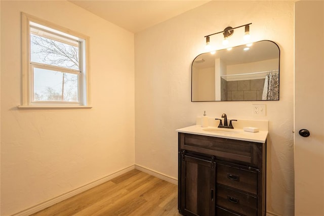 bathroom featuring hardwood / wood-style flooring, vanity, and a shower with curtain