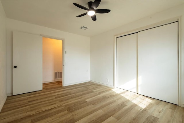 unfurnished bedroom with a closet, ceiling fan, and light hardwood / wood-style flooring