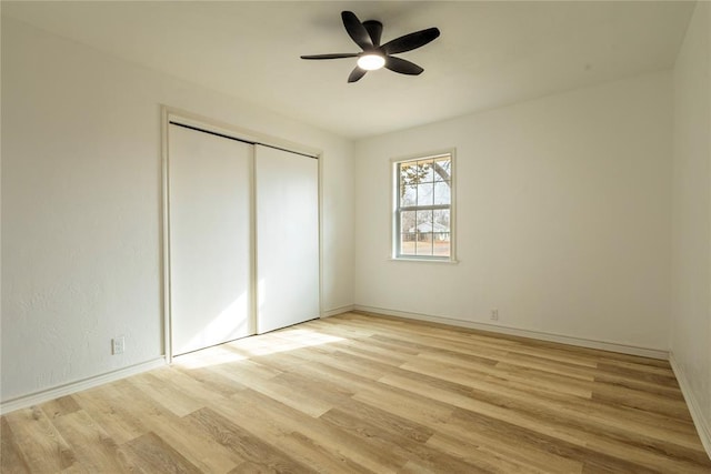 unfurnished bedroom featuring light wood-type flooring, ceiling fan, and a closet