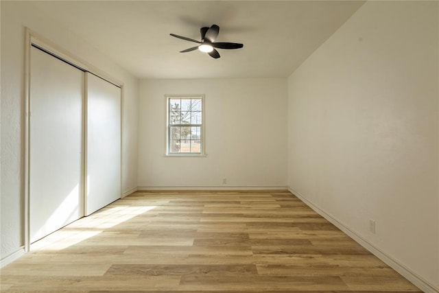 unfurnished bedroom with a closet, ceiling fan, and light hardwood / wood-style flooring