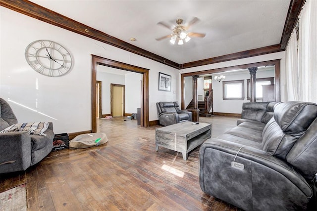 living room with decorative columns, hardwood / wood-style floors, ornamental molding, and ceiling fan