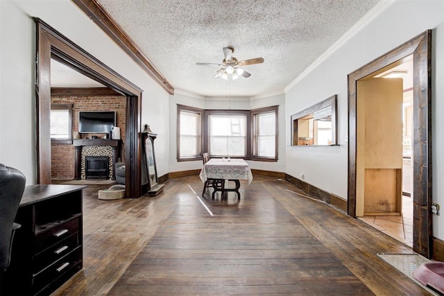 interior space with ceiling fan, a healthy amount of sunlight, dark hardwood / wood-style flooring, and a textured ceiling