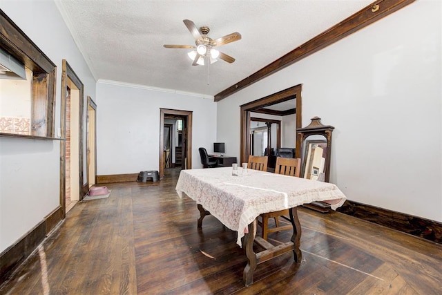 dining space with a textured ceiling, ceiling fan, crown molding, and dark wood-type flooring