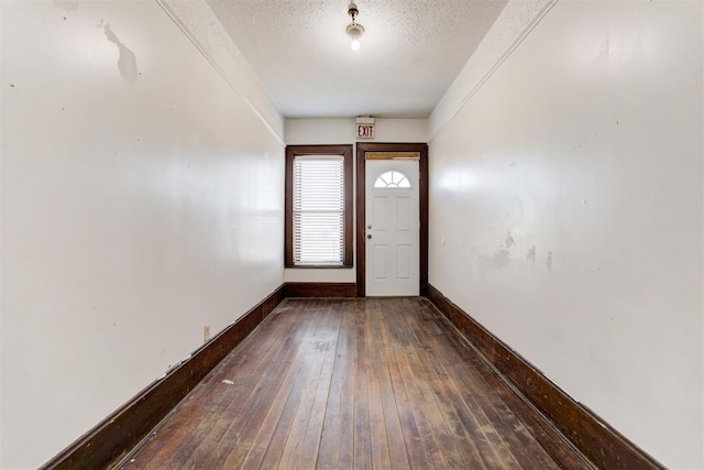 entrance foyer featuring dark hardwood / wood-style flooring and a textured ceiling