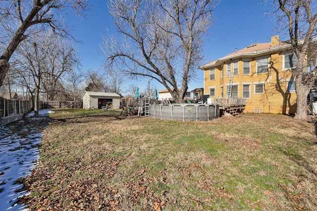 view of yard featuring a fenced in pool and a storage unit