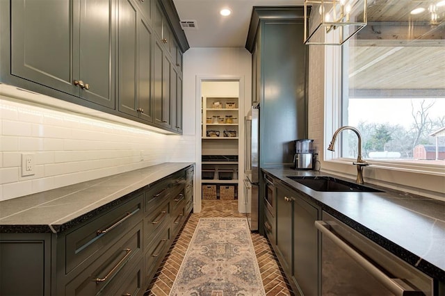 kitchen with appliances with stainless steel finishes, tasteful backsplash, and sink