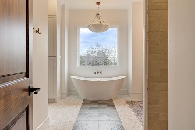 bathroom featuring tile patterned floors and a washtub