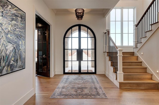 entrance foyer featuring light hardwood / wood-style floors and french doors