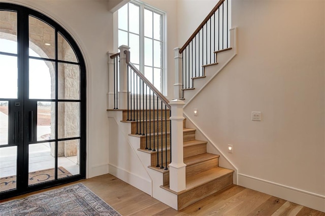 foyer featuring light hardwood / wood-style floors and french doors