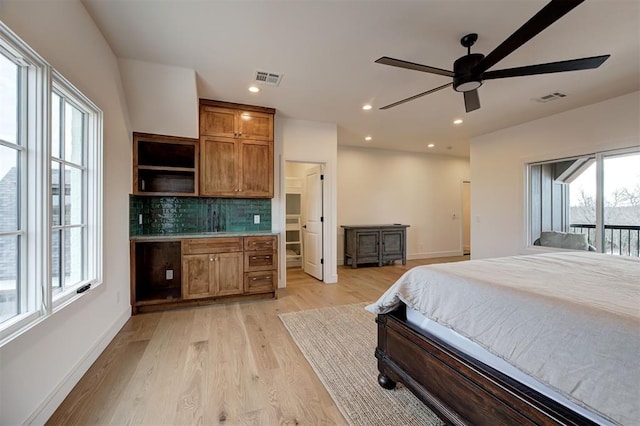 bedroom with ceiling fan, light wood-type flooring, access to outside, and sink