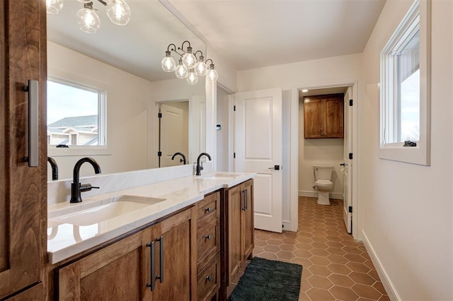 bathroom featuring toilet, vanity, and tile patterned flooring