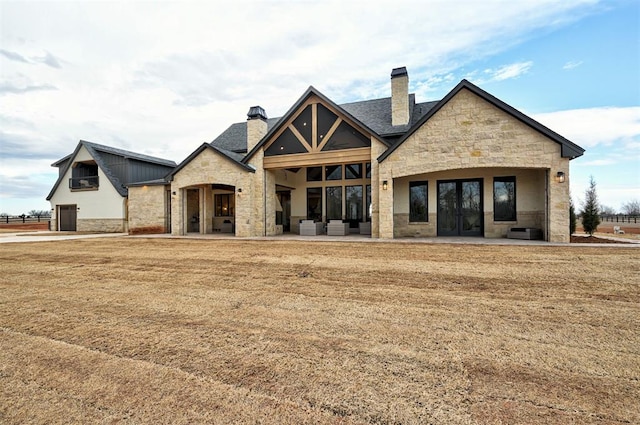 view of front facade with a front lawn, an outdoor living space, and a patio