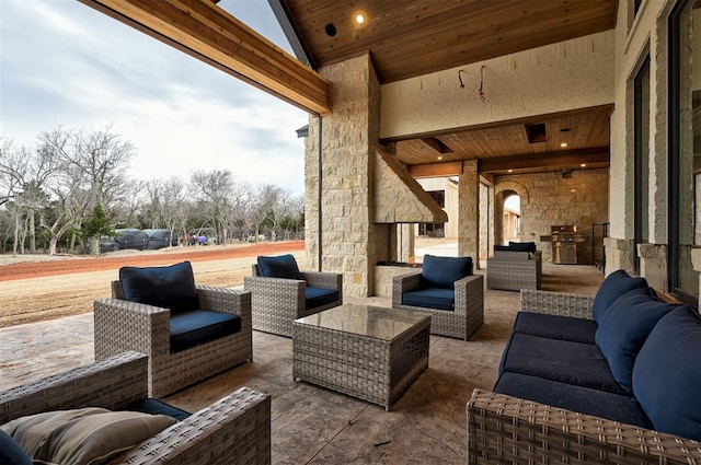 exterior space with a grill and an outdoor living space with a fireplace