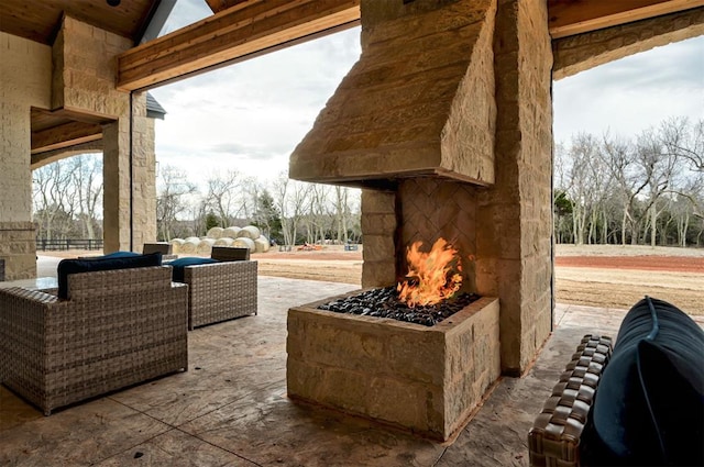 view of patio featuring an outdoor stone fireplace