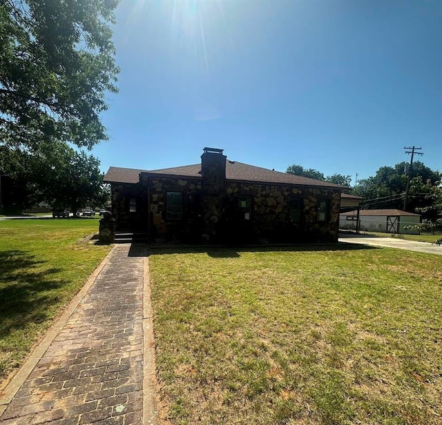 view of front of house with a carport and a front lawn