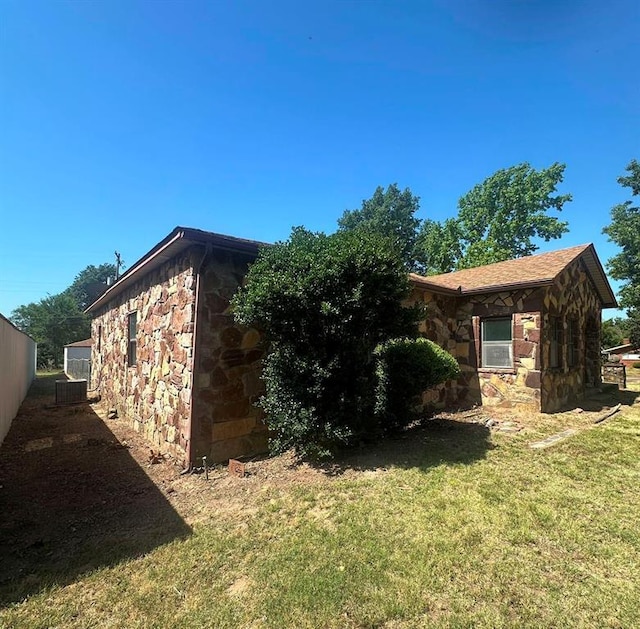 view of side of home featuring a lawn